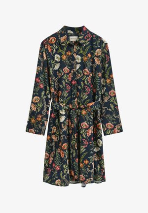 Robe chemise florale à manches longues, faite d'un tissu léger. Présente un fond bleu marine agrémenté de fleurs multicolores et d'une ceinture à nouer à la taille.