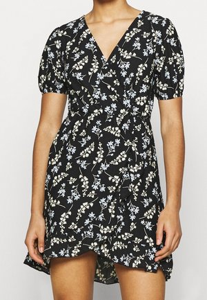 Vestido negro ceñido con mangas cortas abullonadas, que presenta un patrón floral en azul claro y crema, y un dobladillo con volantes. Hecho de una tela ligera.