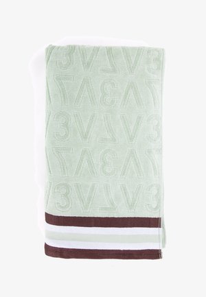 Groene handdoek met een geperst alfanumeriek patroon. Bevat een bruine en witte gestreepte accent aan de onderkant. Zachte textuur, rechthoekige vorm.