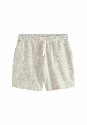 Weiße Strickshorts mit elastischem Bund, Kordelzug, Seitentaschen und dezentem Blumenmuster im gesamten Stoff.