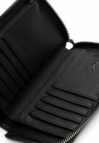 Black leather wallet with zipper closure, features multiple card slots and a textured interior. Minimalist design, no patterns or embellishments.