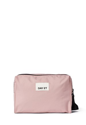 Pink nylon bag with a rectangular shape, black zipper, and a white label that reads "DAY ET." Smooth texture, minimalistic design.