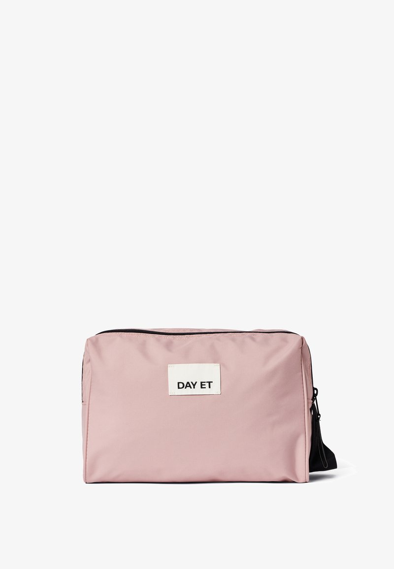 Pink nylon taske med rektangulær form, sort lynlås og et hvidt mærke, der står "DAY ET." Glat tekstur, minimalistisk design.
