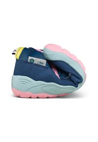 Baskets enfant flexibles et pliables en bleu avec semelle rose et bleu clair, dotées d'une languette jaune et d'étiquettes en tissu visibles.