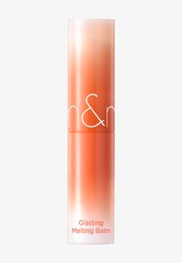 Rund tub av Glasting Melting Balm med en ombre-gradient från ljus persika till djup orange, med vit text och slät yta.