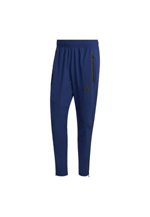 Navy athletic pants with an elastic waistband, side zip pockets, tapered legs, and black branding accents on the lower front.