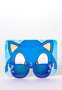 Blauwe kinderzonnebril met een glanzende afwerking, met een Sonic-personage op de poot. De kartonnen achterkant toont een blauw Sonic-ontwerp.