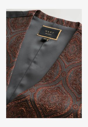 Black satin garment with copper paisley pattern; features a label with "NEXT Occasions." Smooth texture, detailed embroidery accents.