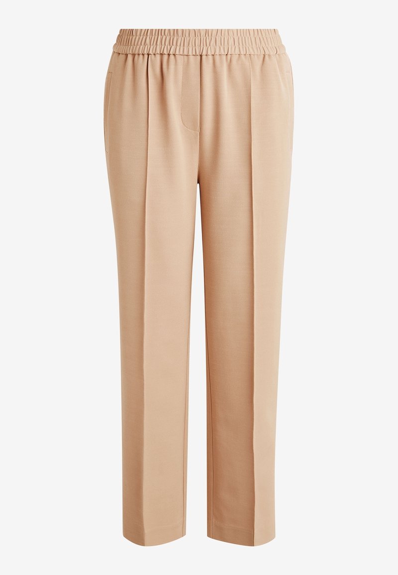 Pantalons larges beiges avec une taille élastique, dotés de poches avant et d'une texture lisse, conçus pour le confort et la facilité de port.