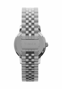 Ezüst Timex óra, kefélt rozsdamentes acél szíjjal és polírozott, kerek tokjával, koronával, minimalista dizájnnal.