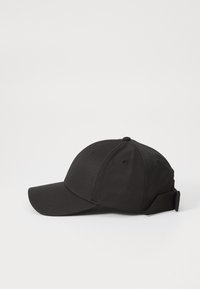 Black baseball cap made of smooth fabric. Features a curved brim, adjustable back strap, and six ventilation eyelets.