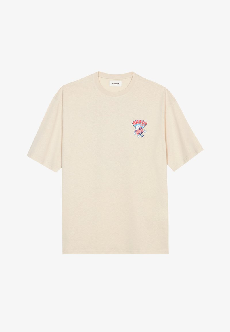 Svijetlo bež pamučna majica s okruglim izrezom i kratkim rukavima. Sadrži šareni crtani grafički uzorak s tekstom "BRAIN" na prsima.