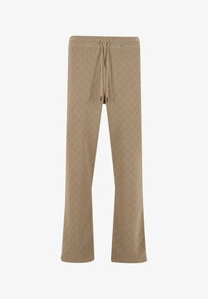 Beżowe spodnie o teksturowanej powierzchni z elastycznym pasem, zawiązywaniem w talii i luźnym krojem, z delikatnym wzorem geometrycznym.