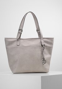 Jasnoszara skórzana torba na ramię z regulowanymi paskami, usztywnionym kształtem, przednią kieszenią i dekoracyjnym frędzlem. Gładka faktura.