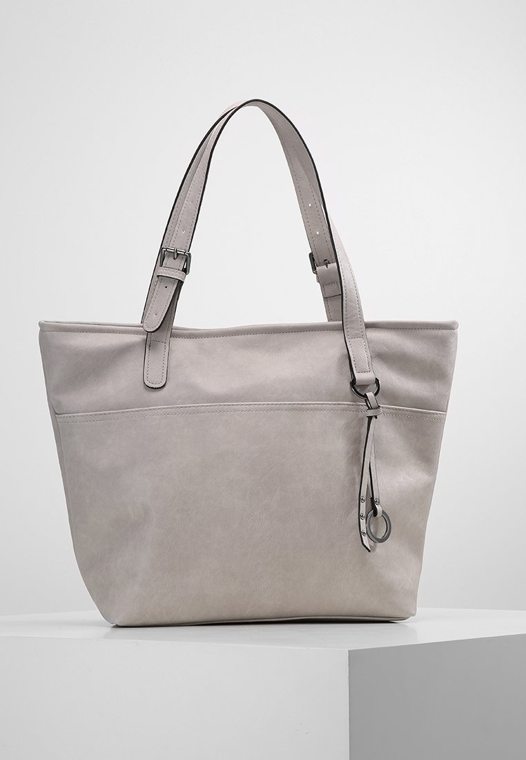 Jasnoszara skórzana torba na ramię z regulowanymi paskami, usztywnionym kształtem, przednią kieszenią i dekoracyjnym frędzlem. Gładka faktura.