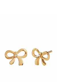Złote kolczyki w kształcie kokardek, z małym przezroczystym kamieniem szlachetnym w środku. Gładka tekstura z wypolerowanymi, zaokrąglonymi krawędziami.
