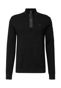 Sudadera de cuello con cremallera en negro, fabricada en un tejido suave. Presenta mangas largas, puños acanalados, un bolsillo con cremallera en la manga y un logo redondo.