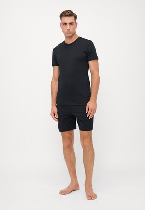 Svart bomull T-skjorte med rund hals, parret med svarte shorts. Begge plaggene er ensfargede uten synlige mønstre eller logoer.