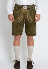 Groene leren shorts met decoratieve stiksels, zijknopen en een riem met een zilveren gesp. Te combineren met beige kniekousen.
