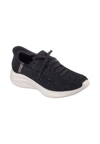 Zapatilla deportiva de punto negra con detalles brillantes, suela blanca, diseño de cordones y logo de Skechers en el talón lateral.
