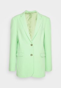 Blazer vert clair avec col à revers cranté, deux boutons devant, poches à rabat et poche poitrine passepoilée, présenté sur un fond neutre.