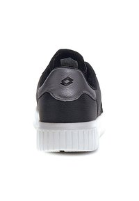 Black sneaker with a textured mesh upper, metallic silver accents, and a white rubber sole with ridged detailing. Back view showcased.