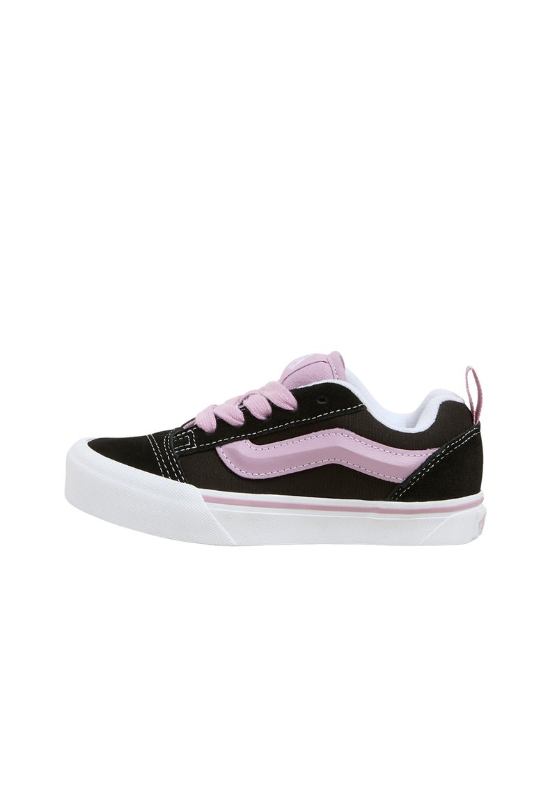 Black and pink low-top sneaker featuring suede material, round toe, contrasting pink side stripe, and white rubber sole with pink accents.