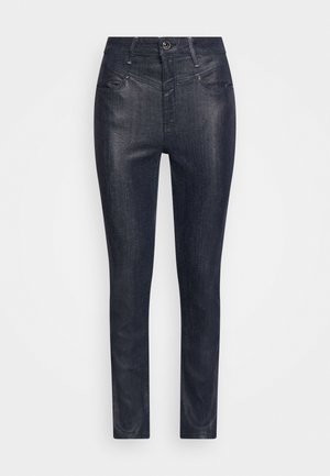 Vaqueros pitillo - coated denim