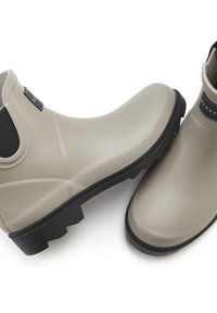 Rubber rain boots in light gray with a smooth finish, black textured soles, and elastic side panels for easy wear. Logo patch on side.