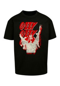 Sort bomulds T-shirt med fed rød og hvid grafisk tekst "OLLY OLLY" og et billede af en figur med hænderne løftet, dateret "U.S. TOUR 1991."