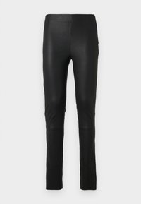 Leggings noirs en tissu lisse et extensible. Design ajusté avec une texture douce. Présente des détails de couture au niveau des genoux.