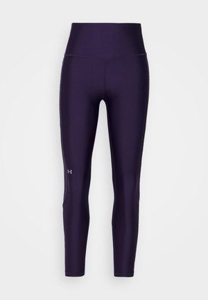 Leggings violettes avec une taille haute, fabriqués à partir d'un matériau lisse et extensible. Présentent un petit logo sur la jambe gauche inférieure et des coutures plates.