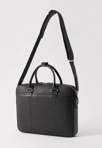 Black leather laptop bag with a textured surface, dual top handles, adjustable shoulder strap, and zipper closure. Smooth accents and stitching details.