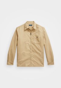 Béžová zipová bunda s límcem, přední kapsou a bočními kapsami. Vyrobena z lehkého materiálu s jemnou texturou.