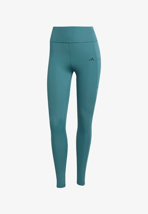 Turquoise high-waisted leggings made from stretchy fabric, featuring a side pocket and a small black logo on the upper thigh.