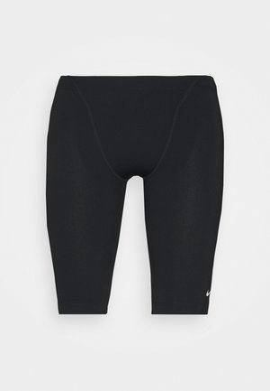 Black athletic shorts made of stretchable fabric, featuring a tight fit, mid-length design, and a subtle Nike logo on the lower side.