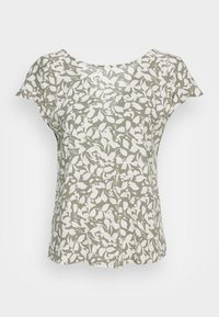 Bluse med blomstermotiv, der har en lys grøn baggrund med hvide bladmønstre. Korte ærmer og rund halsudskæring, lavet af tekstureret stof.
