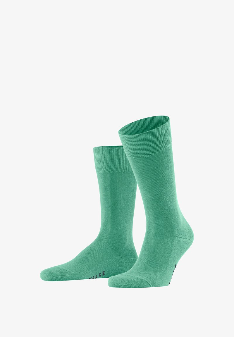 Groene katoenen sokken met een geribde boord en een gladde textuur, met een naadloos te ontwerp en subtiele branding op de zool.