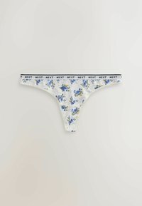 String blanc avec imprimé floral bleu et une ceinture élastique blanche comportant le texte noir répété "NEXT".