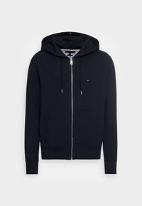 Sudadera con capucha de cremallera en azul marino, confeccionada en algodón suave, con cremallera frontal, dos bolsillos laterales y capucha con cordón y detalles plateados.