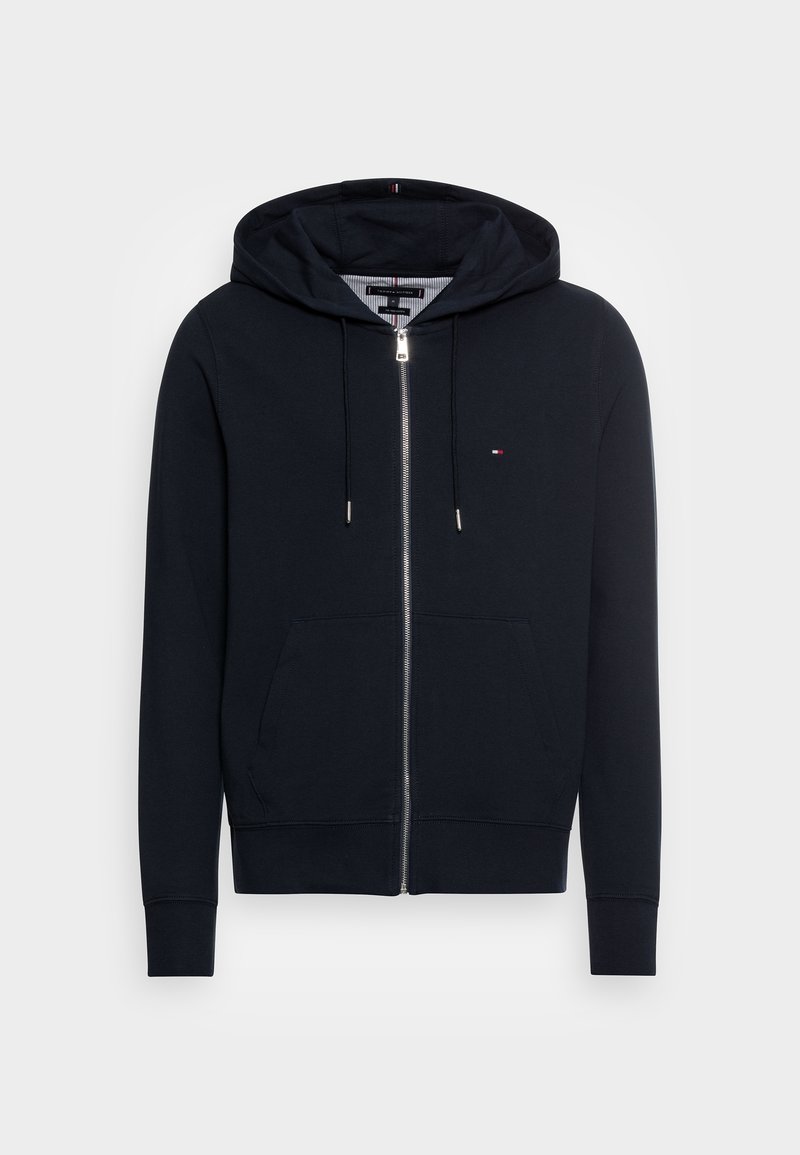 Sudadera con capucha de cremallera en azul marino, confeccionada en algodón suave, con cremallera frontal, dos bolsillos laterales y capucha con cordón y detalles plateados.