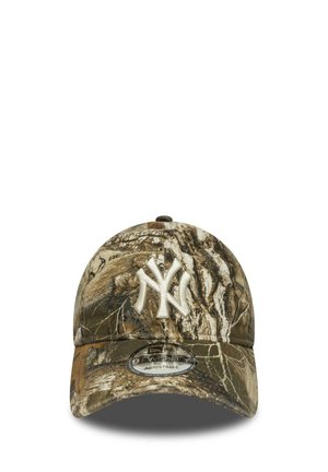 Camo-patterned baseball cap featuring an embroidered white logo, curved visor, and adjustable strap on the back. Cotton blend fabric.