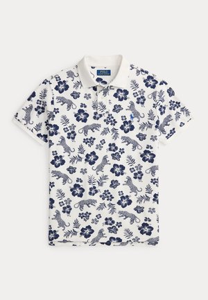 Λευκό πόλο μπλουζάκι με σχέδιο navy λουλουδιών και λεοπάρ, κοντά μανίκια και κλασικό γιακά. Διαθέτει μικρό κεντητό λογότυπο.