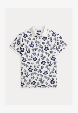 Biele polotričko s námorníckym modrým kvetinovým a leopardím vzorom, krátkymi rukávmi a klasickým golierom. Obsahuje malé vyšívané logo.