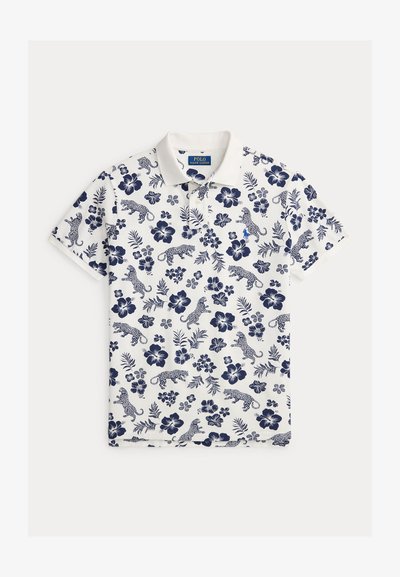 Vit pikétröja med marinblått mönster av blommor och leopard, korta ärmar och en klassisk krage. Har en liten broderad logotyp.