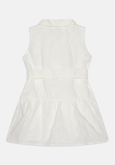 White sleeveless dress featuring a collar, textured floral pattern, flowing tiered hem, and a fitted waist detail.