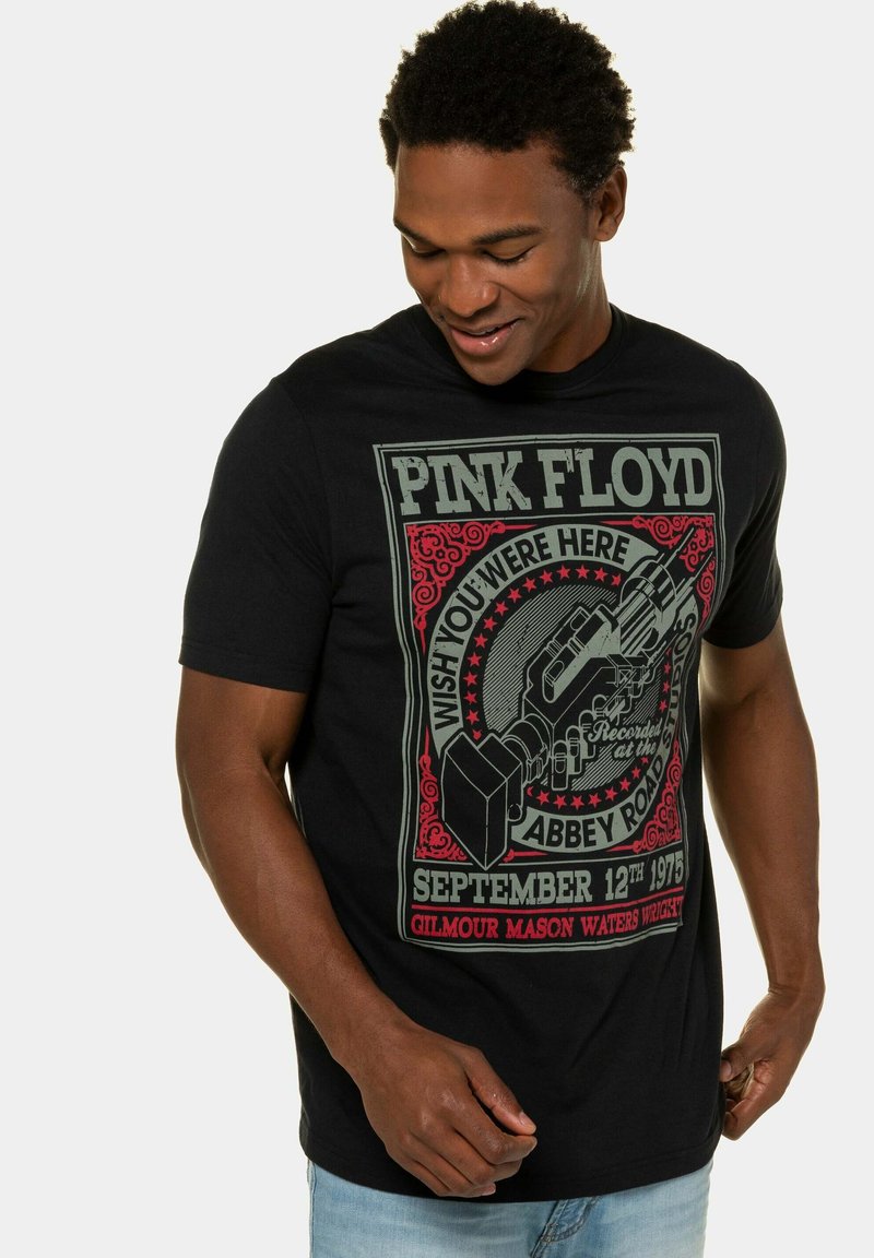 Sort t-shirt med et farverigt grafisk motiv af en mikrofon og teksten "PINK FLOYD WISH YOU WERE HERE ABERY ROAD" på fronten. Korte ærmer.