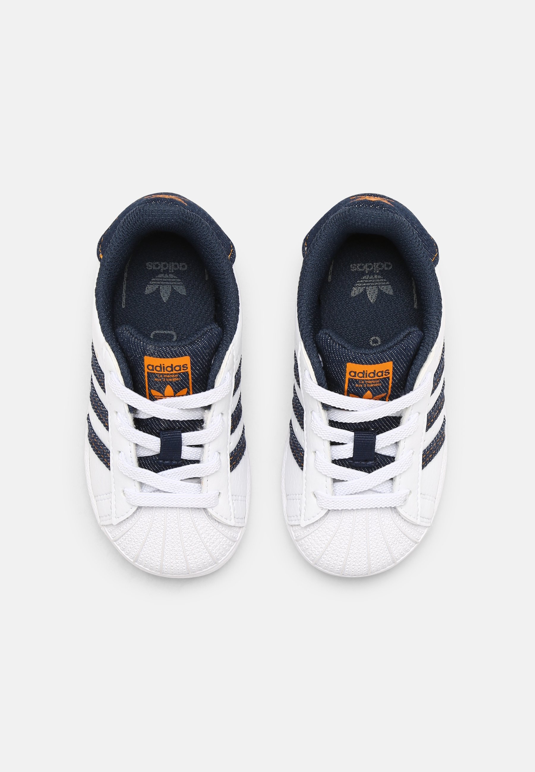 white navy adidas superstar