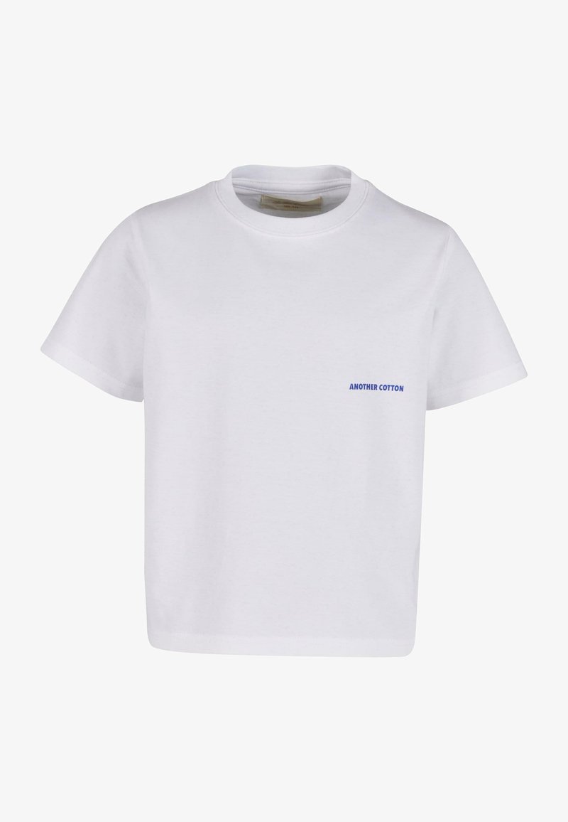 Balts kokvilnas t-krekls ar apaļu kaklu un īsām piedurknēm. Uz kreisās puses ir neliela zila uzraksts "ANOTHER COTTON".