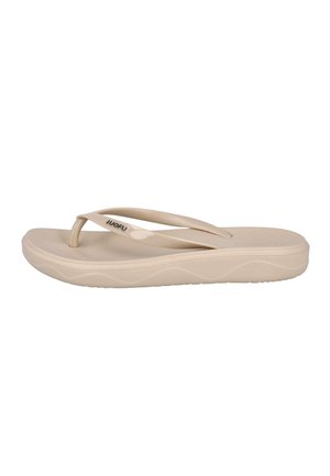 Sandalia flip-flop de goma beige con plantilla texturizada y suela de cuña, con tira en forma de dedo con un pequeño logo de la marca en un lateral.